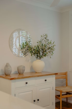 A white cabinet with two vases and a plant on top. - Sanctuary Court 4 Retreat in Currumbin Beach (Currumbin)