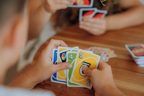 A person holding a deck of cards with visible numbers and symbols. - The Rocks 11H Currumbin Escape with Ocean Views (Currumbin)