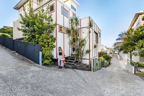 A modern two-story building with a flat roof, a visible staircase, and a gated entrance. - Daybreak Loft at Currumbin Beach with Views (Currumbin)