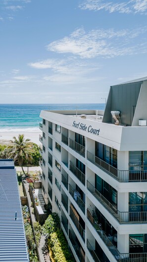A multi-story hotel with balconies overlooking a beach, named 'Surf Side Court'. - Surfside 13 near Palm Beach (Palm Beach)