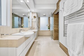 A modern bathroom with two sinks, a glass shower enclosure, and a towel rack. - Joy on Jefferson Stunning Palm Beach Escape (Palm Beach)