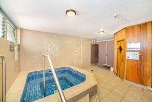 A spa area with a hot tub, a wooden wall, and a control panel. - The Rocks Resort 4C Currumbin Beachfront Apartment (Currumbin)