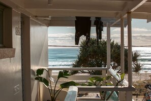 A balcony with a view of the beach and ocean. - White Dolphin 7 Beachfront Currumbin Apartment (Currumbin)
