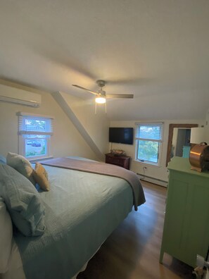 A bedroom with a bed, a ceiling fan, a dresser, and a TV. - Spacious 6-bedroom, 2 Kitchen, 3 bath house in tranquil Old Orchard Beach (Old Orchard Beach)