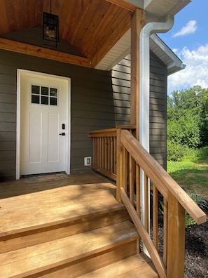 A wooden front porch with a white door and a small window. - Secluded Hot Springs Cabin with Mountain Views & Fire Pit (Hot Springs)