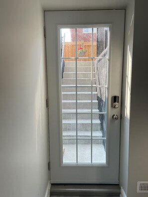 A white door with a glass panel and a metal handle. - LUXE By Marvalous
Luxury 2 bedroom 2 bathroom basement apartment in Brampton. (Brampton)