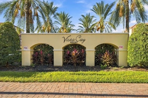 A sign for Vista Cay Resort with a paved walkway in front. - Vista Cay 3BR, Spacious Condo, Sleeps 10 (Orlando)