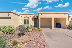 A residential building with a garage, a front door, and a driveway. - Charming Oxford 2BR Pool & Vacation Stay (Tempe)