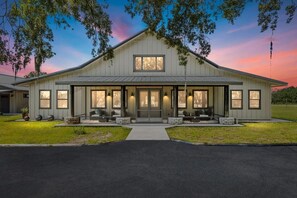 A large, single-story building with a symmetrical facade, a central entrance, and a covered porch area.