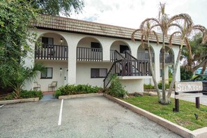 A two-story building with a central staircase, arched balconies, and a sign reading 'SeaMoon'. - Tropical Beach Oasis - Citrus (Cape Canaveral)
