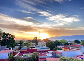 A cityscape with buildings and a sunset. - La Fortaleza I Loft w AC Prime Historic Center Location (Oaxaca)