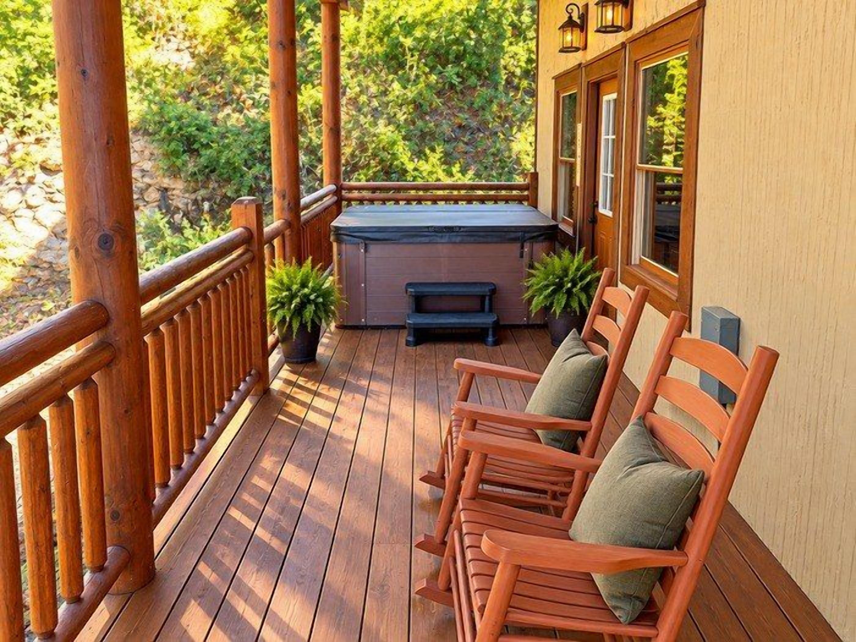 A wooden deck with a hot tub, seating area, and potted plants.