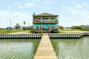 A two-story house with a dock leading to a water body. - The Salt Flat — Waterfront Escape on Salt Lake with Private Pier (Rockport)