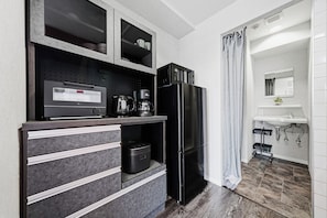 A modern kitchen with a black refrigerator, a coffee maker, and a microwave. - J-STAR 802 (Sapporo)