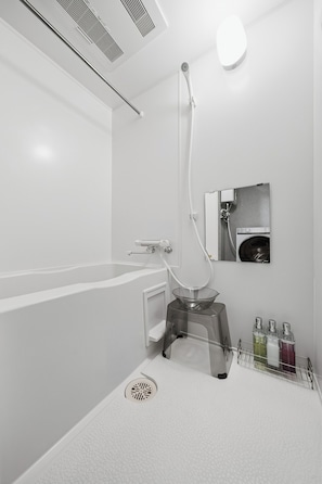 A modern bathroom with a bathtub, a shower, a toilet, and a sink. - J-STAR 802 (Sapporo)