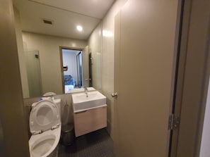 A bathroom with a toilet, sink, and mirror. - 10 minutes walk to BTS bangna BITEC resort style condo 3 swimming pools 2 gyms (Krung Thep Maha Nakhon)