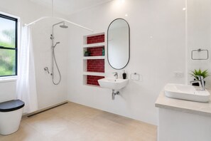 A modern bathroom with a shower, a sink, and a mirror. - Epic Hinterland & Ocean Views - Farm Stay (Mapleton)