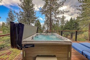 A hot tub on a wooden deck with a view of a forest and sky. - Topaz Lake View at Dollar Point by Tahoe Getaways - Pet-Friendly 5BR w/ Private Hot Tub (Tahoe City)