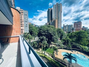 A residential building with a rooftop pool and surrounding greenery. - New Listing (Medellín)