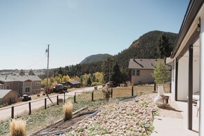 A residential area with houses, a mountain in the background, and a clear sky.