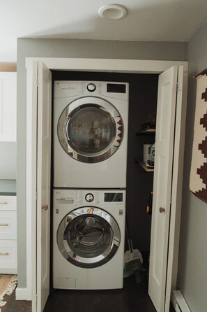 A laundry room with two stacked front-loading washing machines.