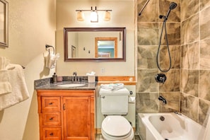 A bathroom with a sink, toilet, and bathtub. - Rabbit House | Your Summit County Mountain Retreat (Silverthorne)