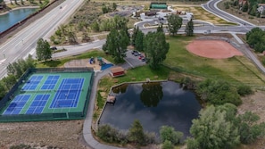 An aerial view of a sports complex with tennis courts, a baseball field, and a pond. - Rabbit House | Your Summit County Mountain Retreat (Silverthorne)