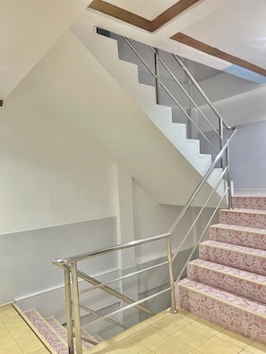 A modern staircase with metal railings and patterned steps. - Innarm House Patong  (Kathu District, Phuket, Thailand.)