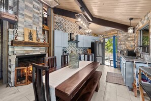 A modern kitchen with a stone backsplash, wooden beams, and a built-in stove. - Welcome to "THE VOC" (Sedona)