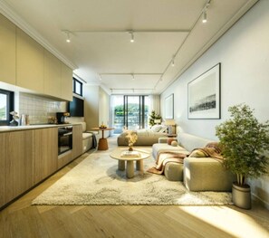 A modern living room with a sofa, coffee table, and a view of the outdoors. - The Landing Studio 1003 Cape Town CBD (Cape Town)