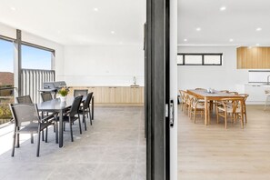 Outdoor dining area connected to the open-plan kitchen and dining space. - Indented Head Coastal Retreat | 5BR Escape (Indented Head)