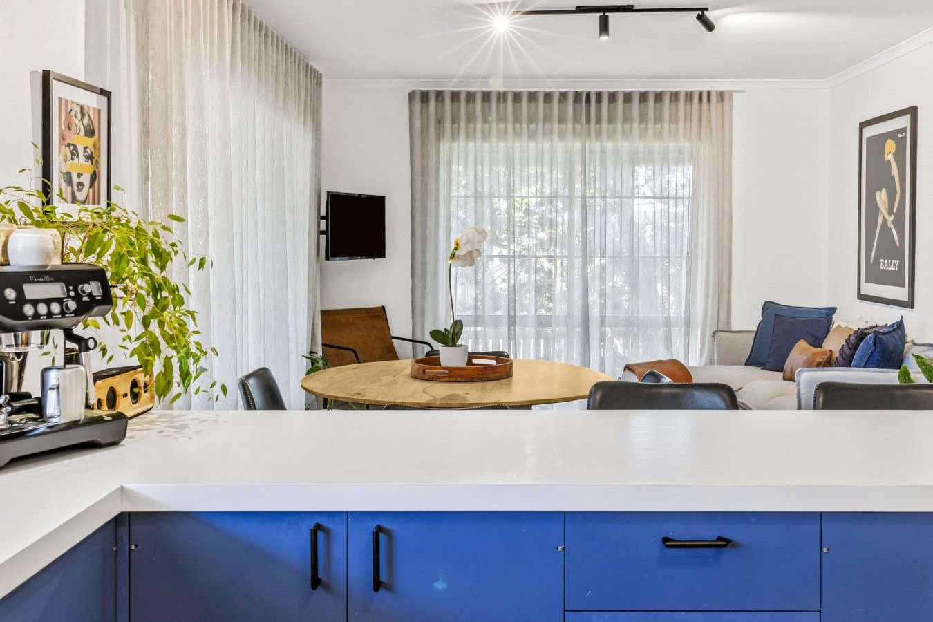 Open-plan living and dining area with natural light and modern furnishings.