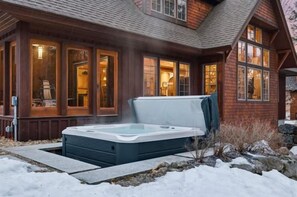 A wooden house with a hot tub in the front yard. - Ski Trail to Door | Hot Tub, Games & Gym (Lincoln)