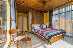 A bedroom with a wooden bed, a ceiling fan, and a large window with curtains. - May Villa 6BR Beachside An Bang Beach Hoi An by Beachside Boutique Homes (Đà Nẵng)