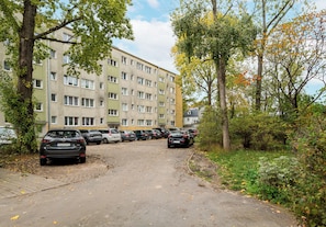 A multi-story residential building with a parking area in front. - Praga Ostrobramska Lavish Apartment (Warszawa)