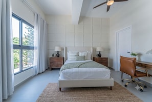 A bedroom with a large window, a bed, a desk, and a chair. - 2 - bedroom skyline Oasis Over Santo Domingo DR (Santo Domingo)