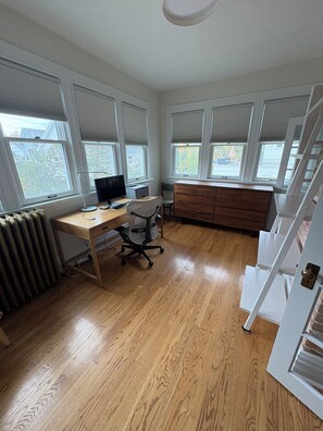 A room with a wooden desk, a chair, a dresser, and a radiator. - Historic 4BR and 3 Bath, University District Home, Sleeps 8, Near UM & Downtown (Missoula)