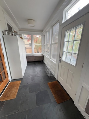 A kitchen with a built-in refrigerator, a window seat, and a door with a glass panel. - Historic 4BR and 3 Bath, University District Home, Sleeps 8, Near UM & Downtown (Missoula)