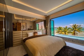A modern bedroom with a large bed, a view of the ocean, and a balcony with palm trees. - Saengsuree Villas Koh Yao Yai (Koh Yao)