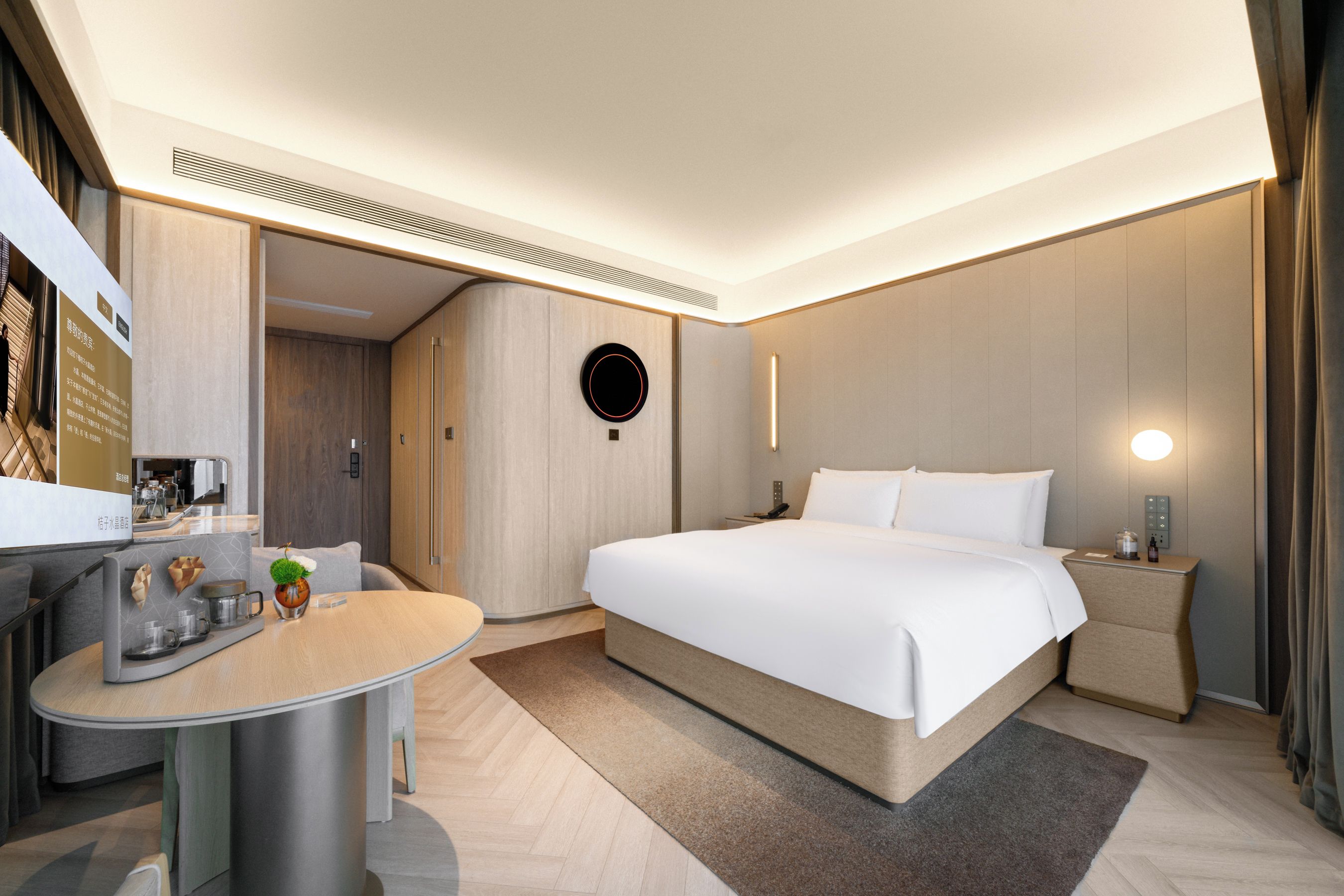 Una camera d'albergo moderna con un letto, un comodino e una scrivania con una sedia.