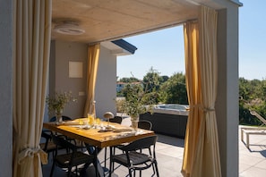 A patio with a table set for dining, outdoor chairs, and potted plants. - Villa Sanja (100711-K1) - Vizinada (Porec) (Vizinada (Porec))