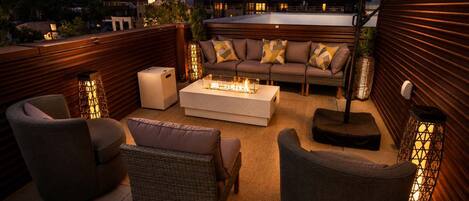 An outdoor seating area with a sofa, chairs, and a coffee table.