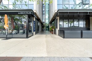 A modern building with a storefront labeled 'MOLTO ITALIAN' and a covered outdoor seating area. - Kingston 1BR in a Central Foreshore Location (Canberra (Inner South))