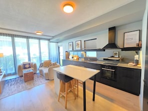 A modern apartment with a kitchen, dining area, and living room. - Kingston 1BR in a Central Foreshore Location (Canberra (Inner South))