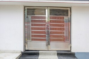 A double door with horizontal metal bars and a metal handle.
