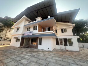 A two-story building with a signboard indicating it houses a surgical hospital and a psychiatric clinic.