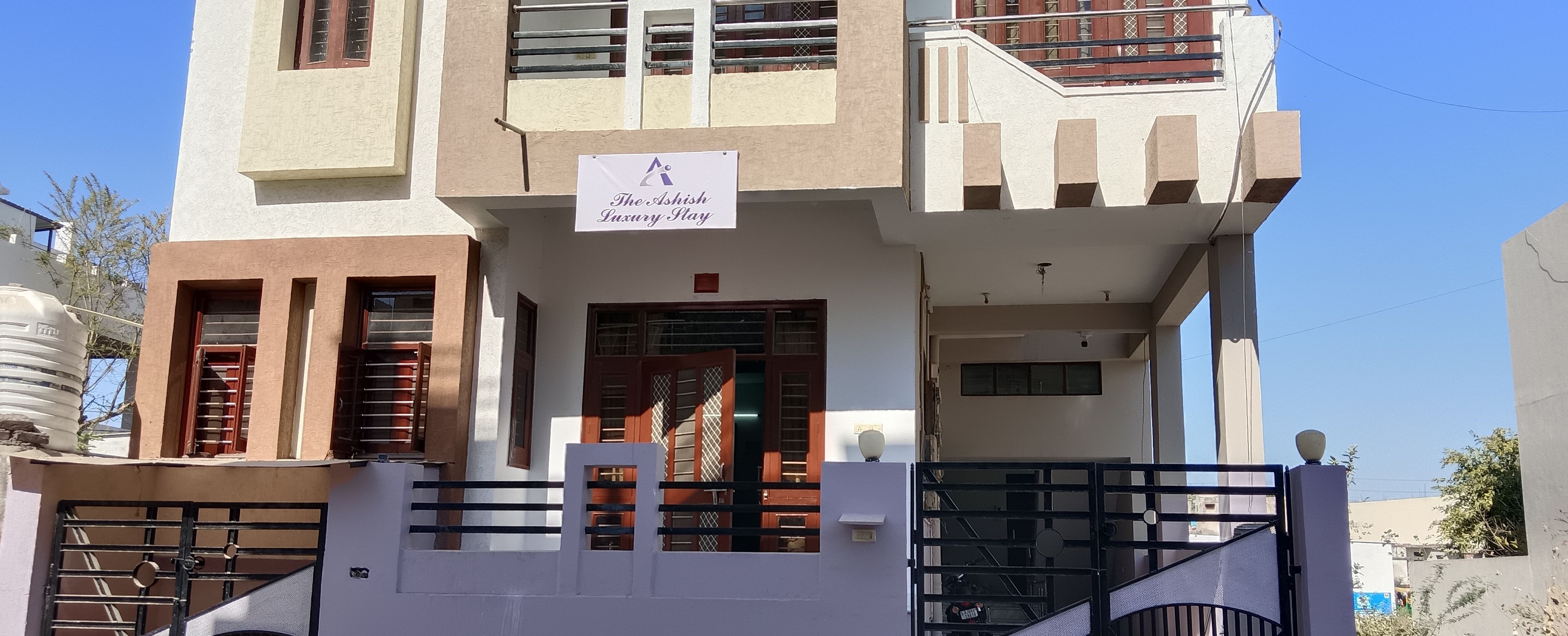 A multi-story building with a sign indicating 'The Ashish Luxury Play.'