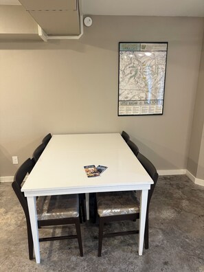 A conference table with two chairs, a framed map on the wall, and a small booklet on the table. - Tranquil 1-bedroom guest suite In Bella Vista Hills (Bella Vista)