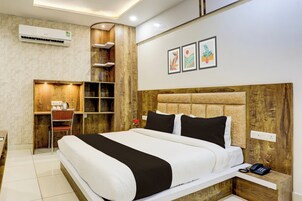 A modern bedroom with a large bed, wooden headboard, and a built-in wardrobe.