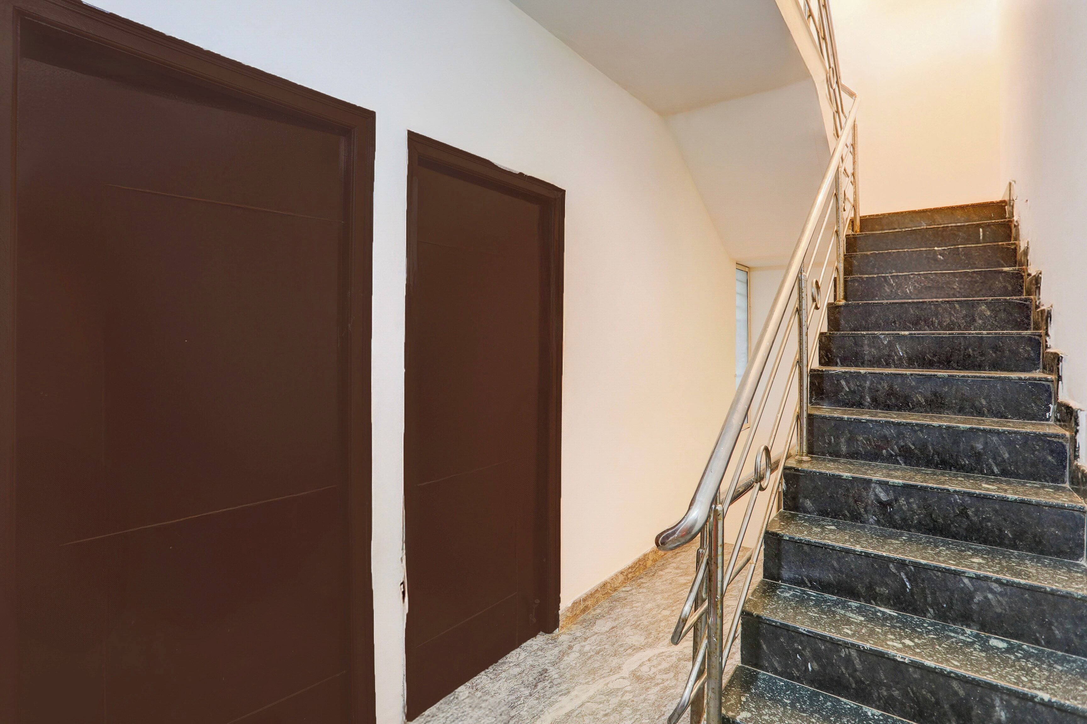 A staircase with metal railings leading to a landing.